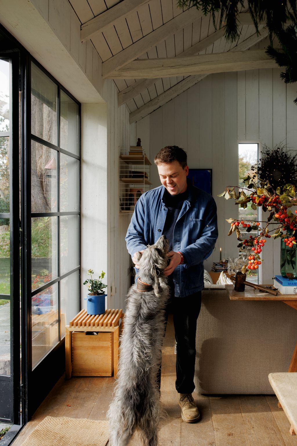 Image may contain Nico Muhly Plant Potted Plant Door Face Head Person Photography Portrait Adult and Indoors