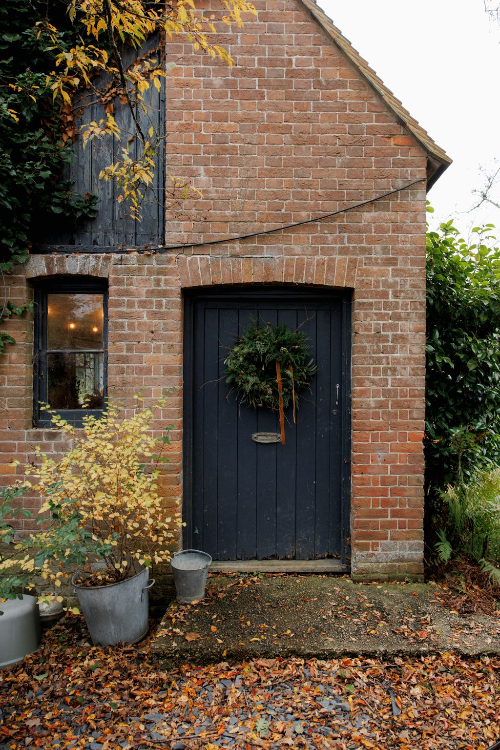 Image may contain Brick Garage Indoors Plant Tree and Door