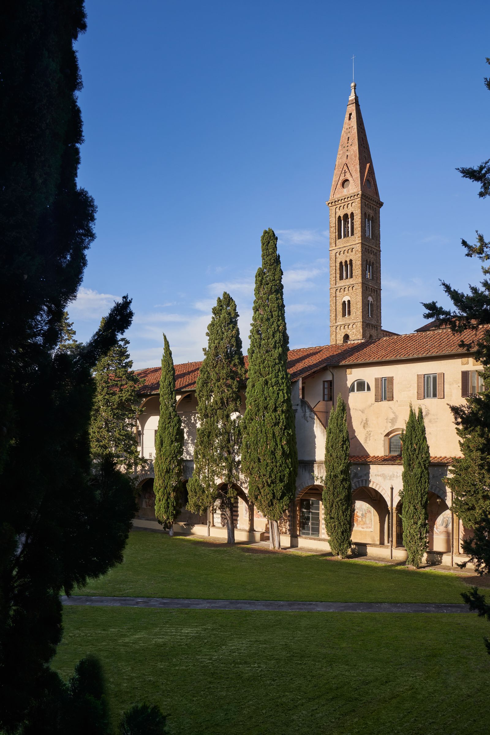 Image may contain Architecture Building Spire Tower Monastery Bell Tower Plant Tree Grass Arch and Conifer
