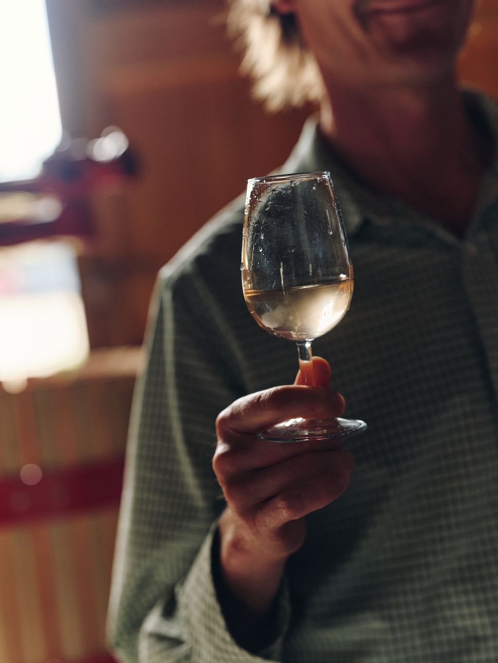 Image may contain Glass Alcohol Beverage Liquor Wine Wine Glass Adult Person Outdoors Body Part Finger and Hand