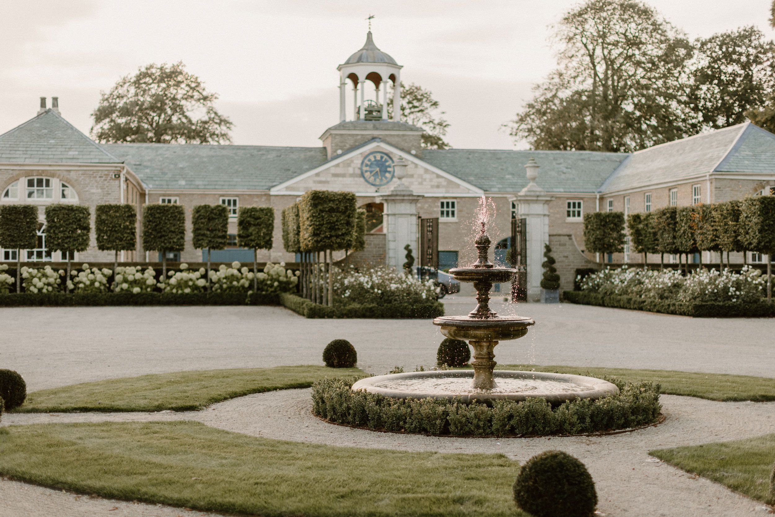 Image may contain: Architecture, Fountain, Water, Grass, Plant, Building, Clock Tower, and Tower