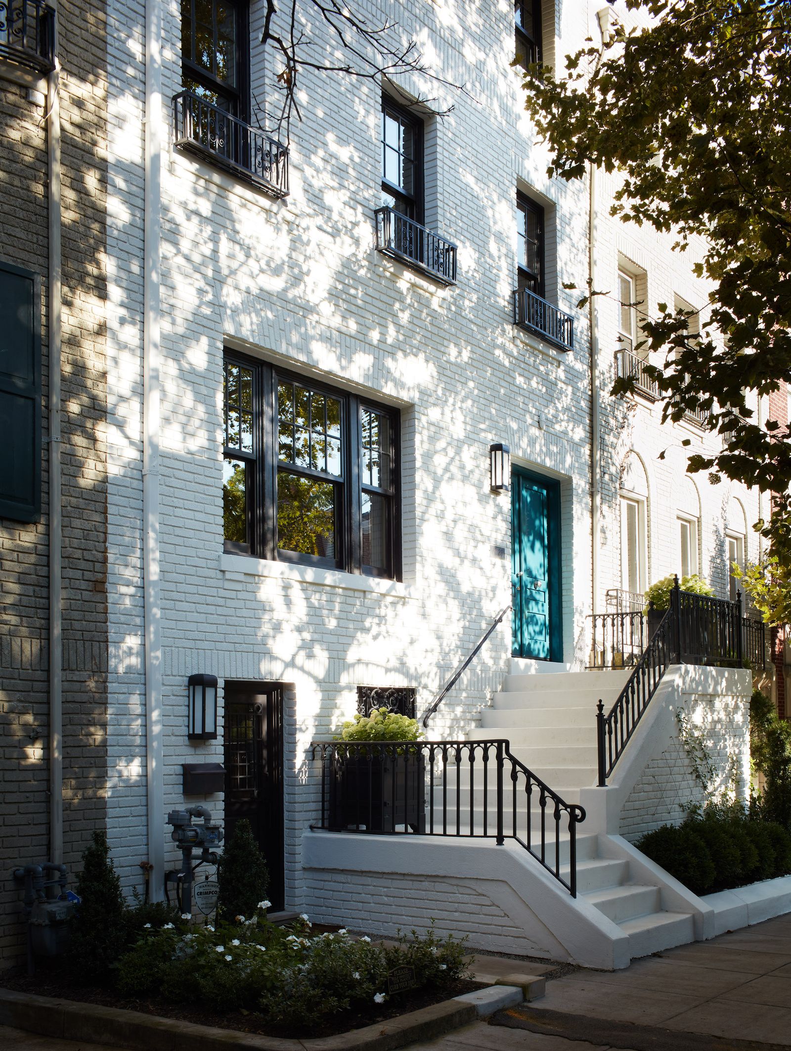 exterior of period house in Washington DC whitewashed brick townhouse