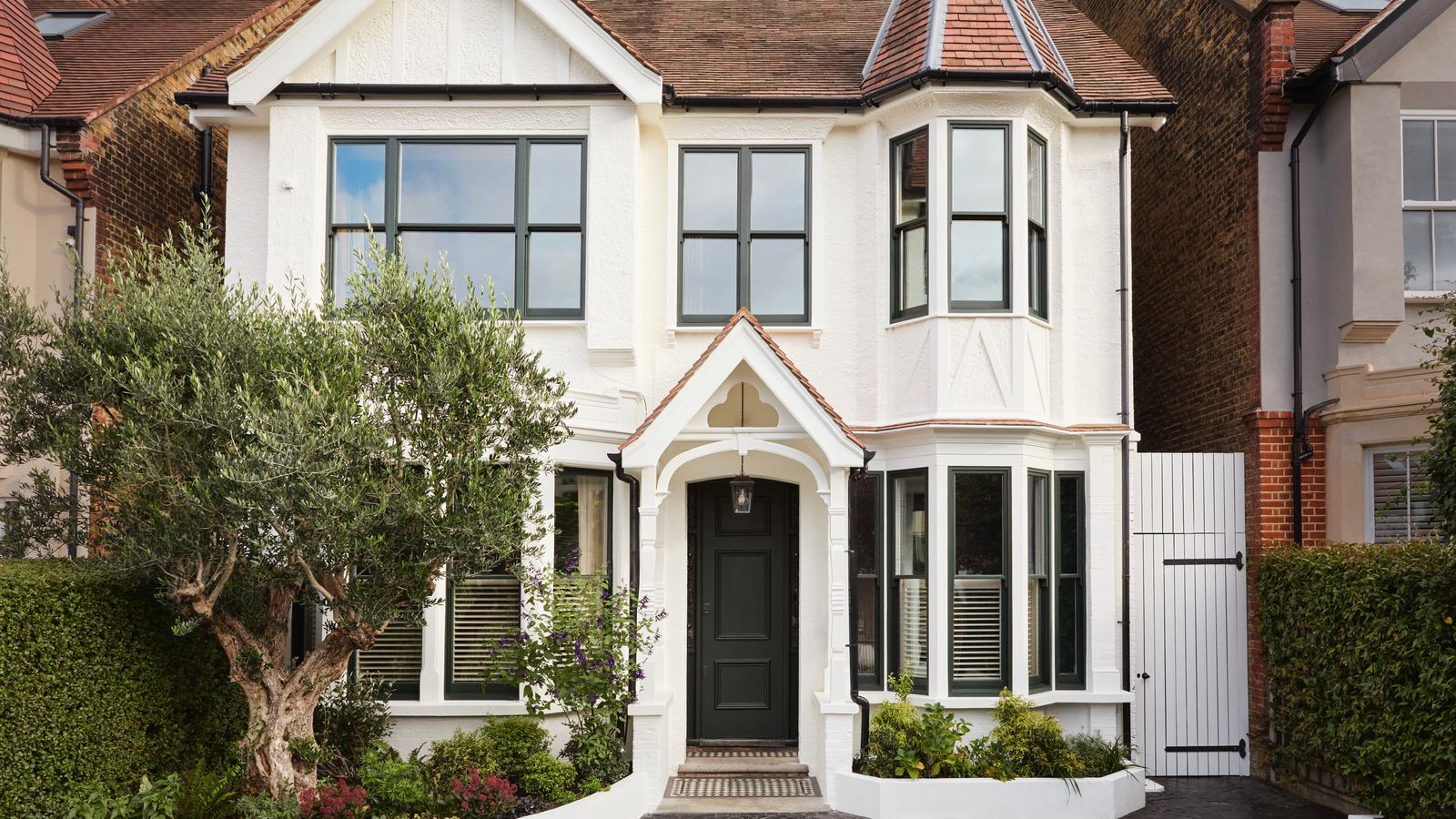 Image may contain Architecture Building Housing Window House Portico Lamp and Bay Window